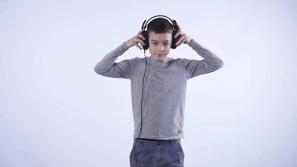 Happy teen boy with headphones, isolated on white background — Stock Video