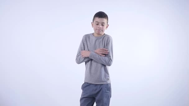 Portrait of confused clueless boy against white background. — Stock Video