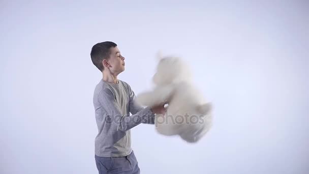 Boy catches a teddy bear isolated on white background — Stock Video