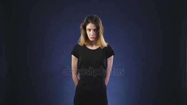 A young girl with angry face dark background — Stock Video