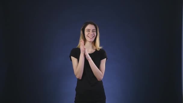 Happy and laughing woman over dark background — Stock Video