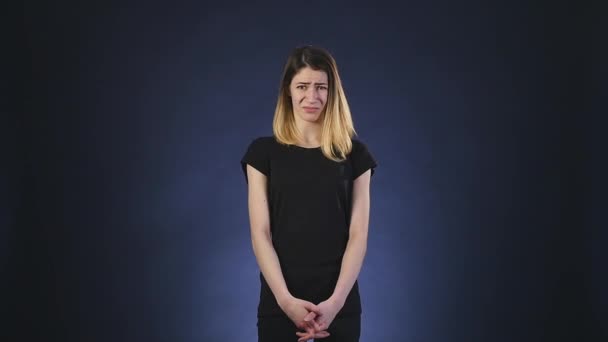 Disgusting emotion. girl on dark background — Stock Video
