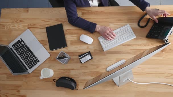 Vista de ángulo alto de una joven morena que trabaja en su escritorio de oficina con documentos y laptop. Empresaria trabajando en el papeleo — Vídeo de stock