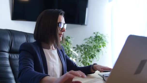 Junge Frau dehnt sich, arbeitet, macht Hausaufgaben, mit Notebook und Laptop — Stockvideo