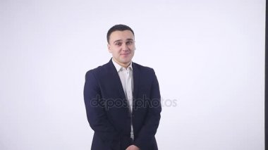 Gülümseyerek, kamera beyaz arka plan üzerinde seyir utangaç yakışıklı delikanlı
