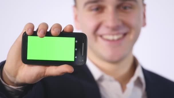 Smart phone with green screen in hand of businessman — Stock Video