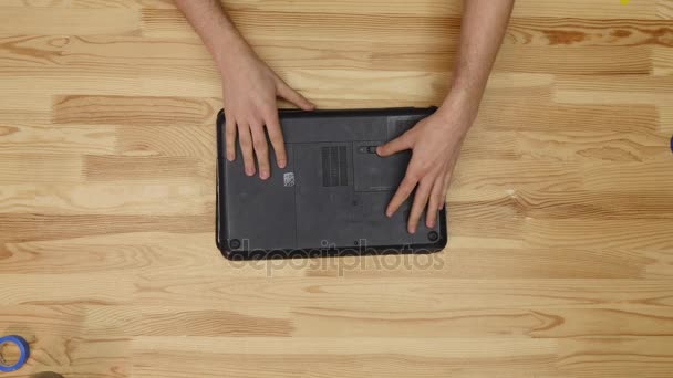 Αρσενικό μηχανικός επισκευές laptop. Ξύλινο τραπέζι κορυφαία προβολή — Αρχείο Βίντεο