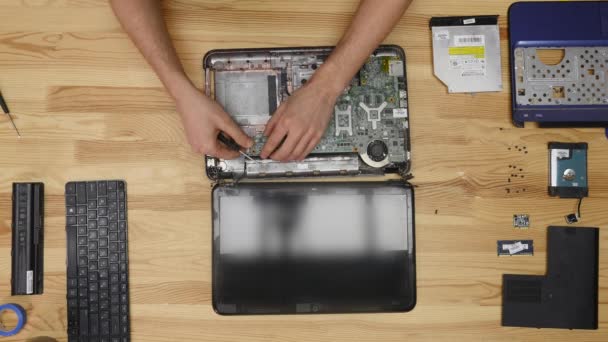Ingeniero masculino repara laptop. Mesa de madera vista superior — Vídeo de stock