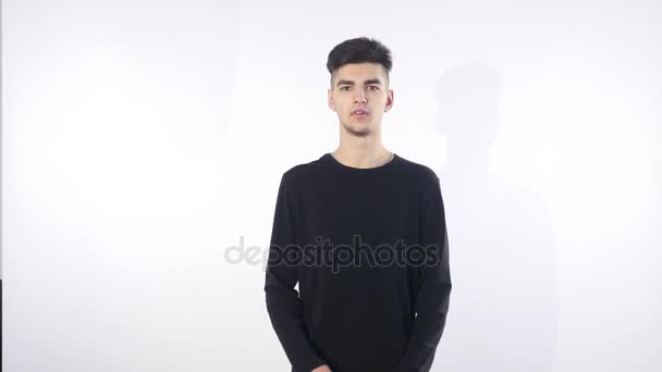 Handsome young man thinking on something, isolated on white background — Stock Video