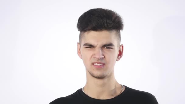 Lack of confidence. Shy young handsome man feels awkward isolated on grey wall background. Human emotion body language life perception — Stock Video