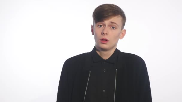 One young man caucasian walking sad bore side view in studio white background — Stock Video