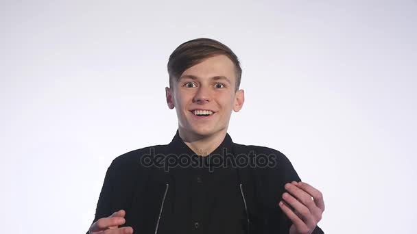 Surprised young handsome man in hat smiling, laughing over white background. Slow motion — Stock Video