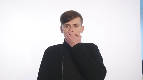 Scared young man against white background — Stock Video