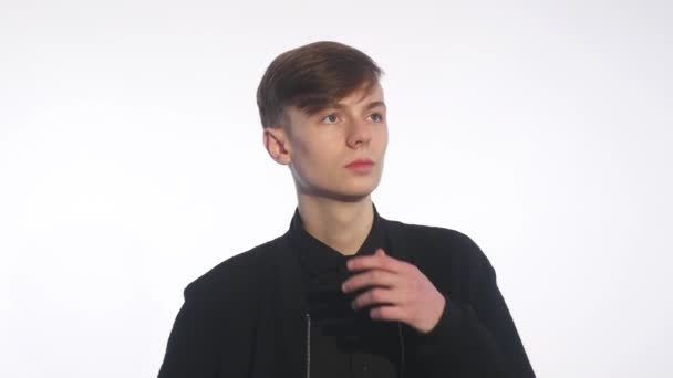 Young man thinks a white background — Stock Video