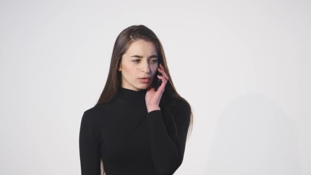 Close up of woman on her cellphone against a white background — Stock Video