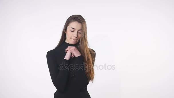 Closeup of young sexy lady posing during professional photosession in photo studio isolated on white background. Girl is flirting and biting her lip — Stock Video