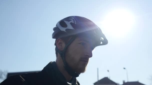 Professional cyclist with a beard wearing glasses — Stock Video