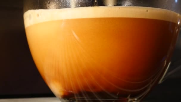 Кофеварка наливая эспрессо в чашку чрезвычайно крупным планом — стоковое видео