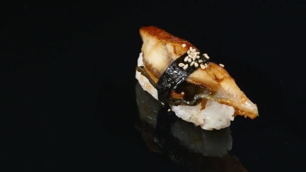 Sushi on black background rotating close up — Stock Video