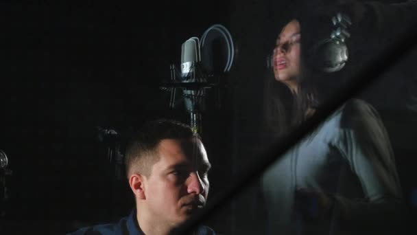 Woman is recorded in the recording studio with a sound engineer — Stock Video