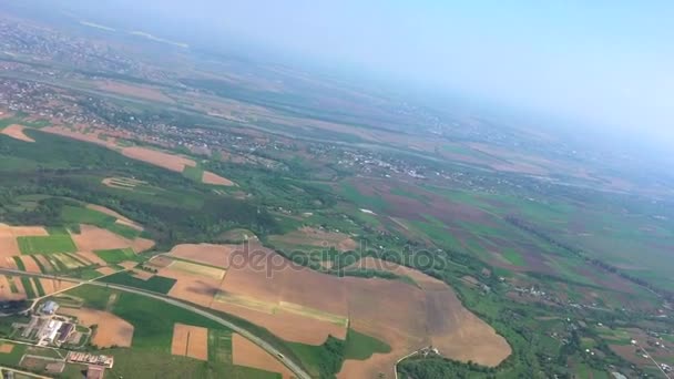 View on landscape of fields and river from window of flying plane — Stock Video