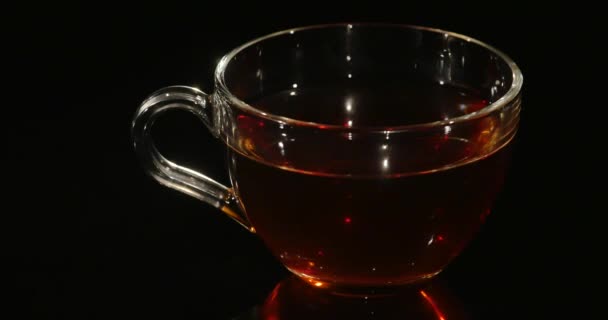 Cup of tea rotation on the black background — Stock Video