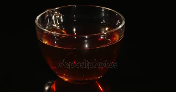 Cup of tea rotation on the black background — Stock Video