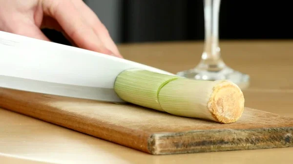 Female hands cut up the vegetable into slices