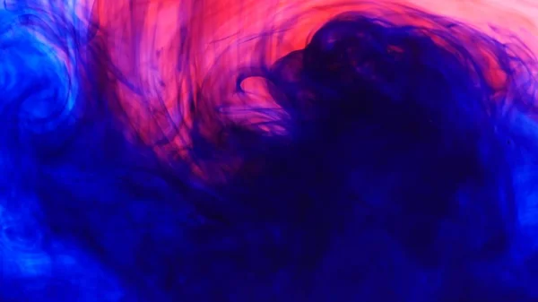 Luminoso sfondo colorato Blu e rosso Colori inchiostro liquido miscelazione in acqua — Foto Stock