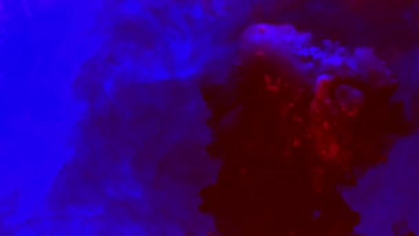 Liquides colorés tombés dans l'eau. Bleu et rouge mélangés en violet. Couleur tombant Couleur étalée — Video