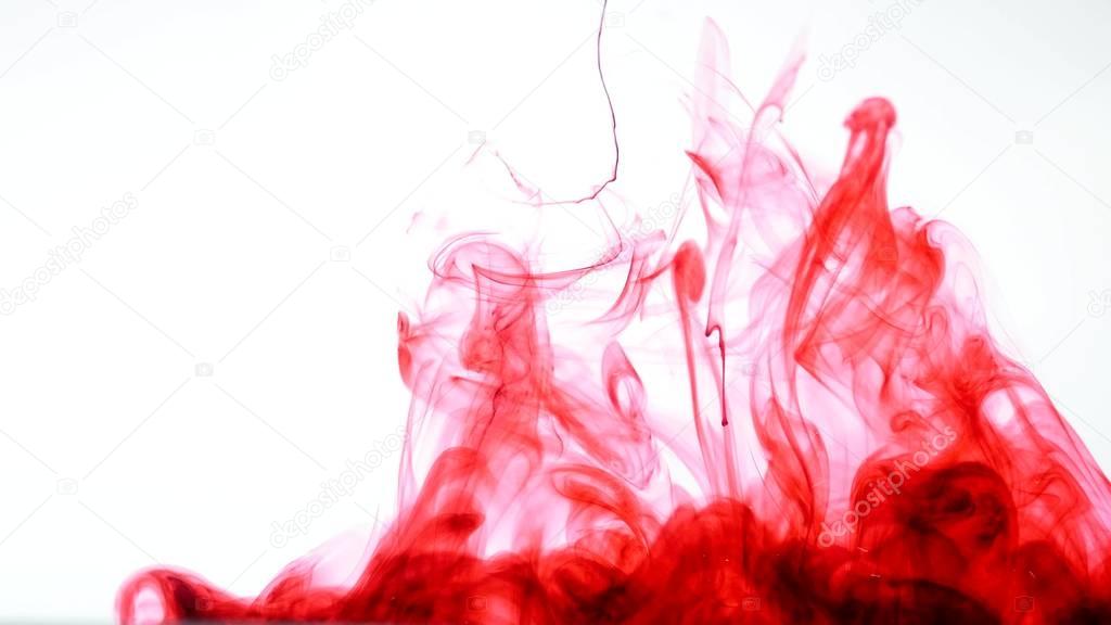 Red ink in water. Abstract