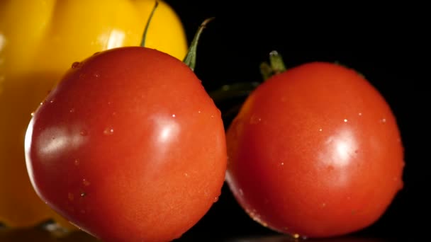 Yellow bell pepper and tomato s on a black background — Stock Video