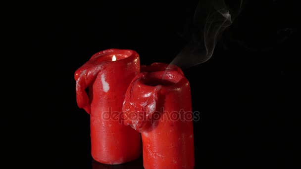 Close up 3 lit red candles rotating around black background — Stock Video
