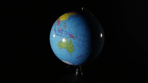 Nahaufnahme Globus rotierend auf schwarzem Hintergrund — Stockvideo