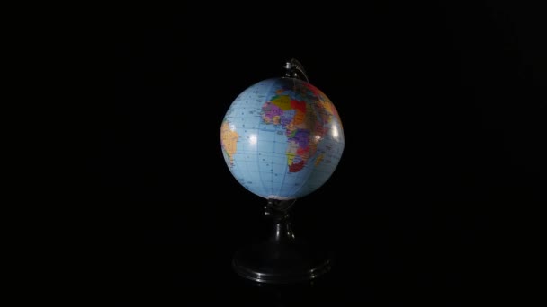 Close up globe rotating on black background — Stock Video