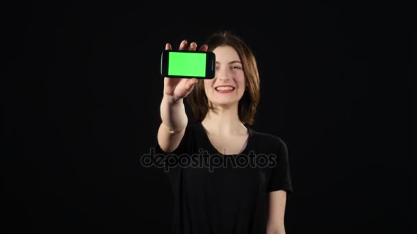 Young woman hands showing blank smartphone screen isolated on green background — Stock Video