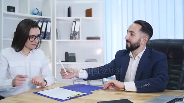 Business, cooperation, partnership, deal and people concept - man and woman signing contract and shaking hands at office — Stock Video