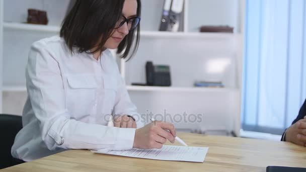 Real estate agent signing contract and giving keys to female client — Stock Video