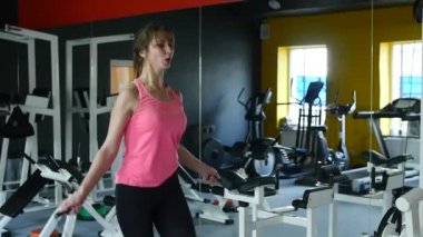 İp atlama ve sağlıklı rutin ile spor salonunda fitness üzerinde çalışan genç atletik kadın