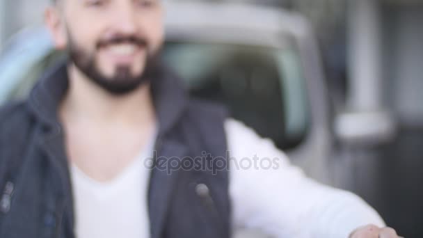 Happy young man holding keys to new car. selective focus