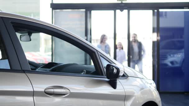 Young family comes into Car dealership to choose the car to buy it — Stock Video