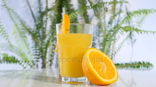 テーブルの上のオレンジとオレンジ ジュースの回転 — ストック動画