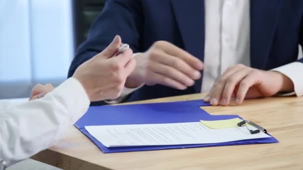 Businesswoman signs a contract and shakes hands on the deal — Stock Video