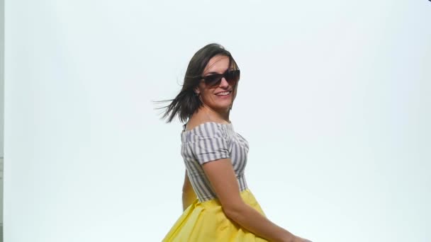 Pretty happy smiling woman with her hands up in the air playing with beautiful silk scarf against on a white background — Stock Video