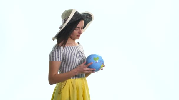 Beautiful woman pointing at the globe where it wants to go — Stock Video