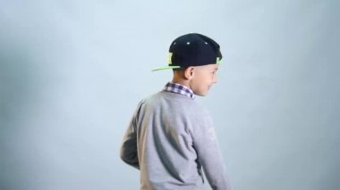 Dişsiz bir gülümseme ile çocuk kendini döner ve sınıf gösterir