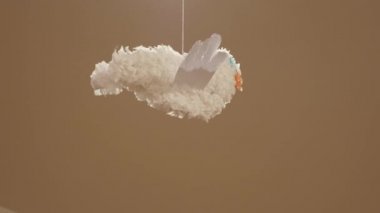 Kahverengi arka plan iş parçacığı üzerinde dönen kağıt origami turna