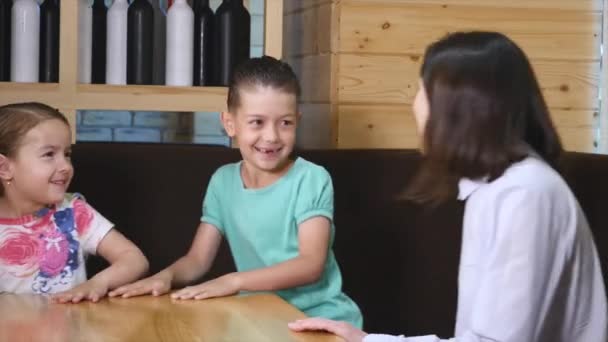 Familjen sittande bord tillsammans i ett café — Stockvideo