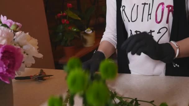 Blumenladen, Blumengeschäft, das moderne Bouquet arrangiert, junge hübsche Floristen arbeiten im Blumengeschäft, das Bouquet herstellt — Stockvideo