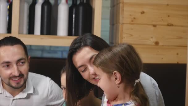 Happy family sitting table together in a cafe — Stock Video